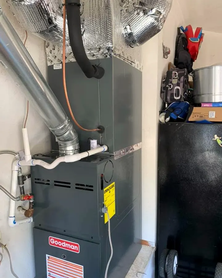 Goodman gas furnace in a garage with its venting and gas line
