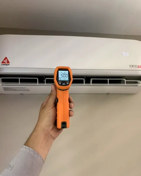Infrared thermometer checking the air coming out of a ductless mini-split